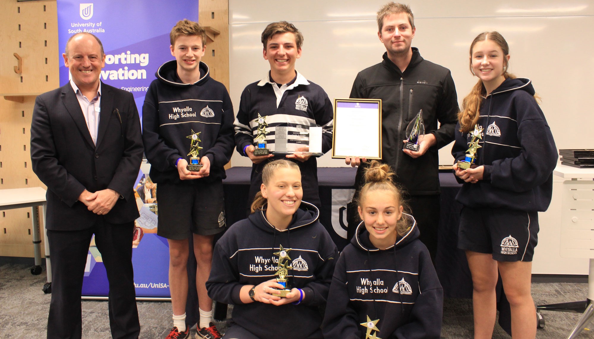 The winning team of 6 students and their teacher from Whyalla High School receiving their award. 