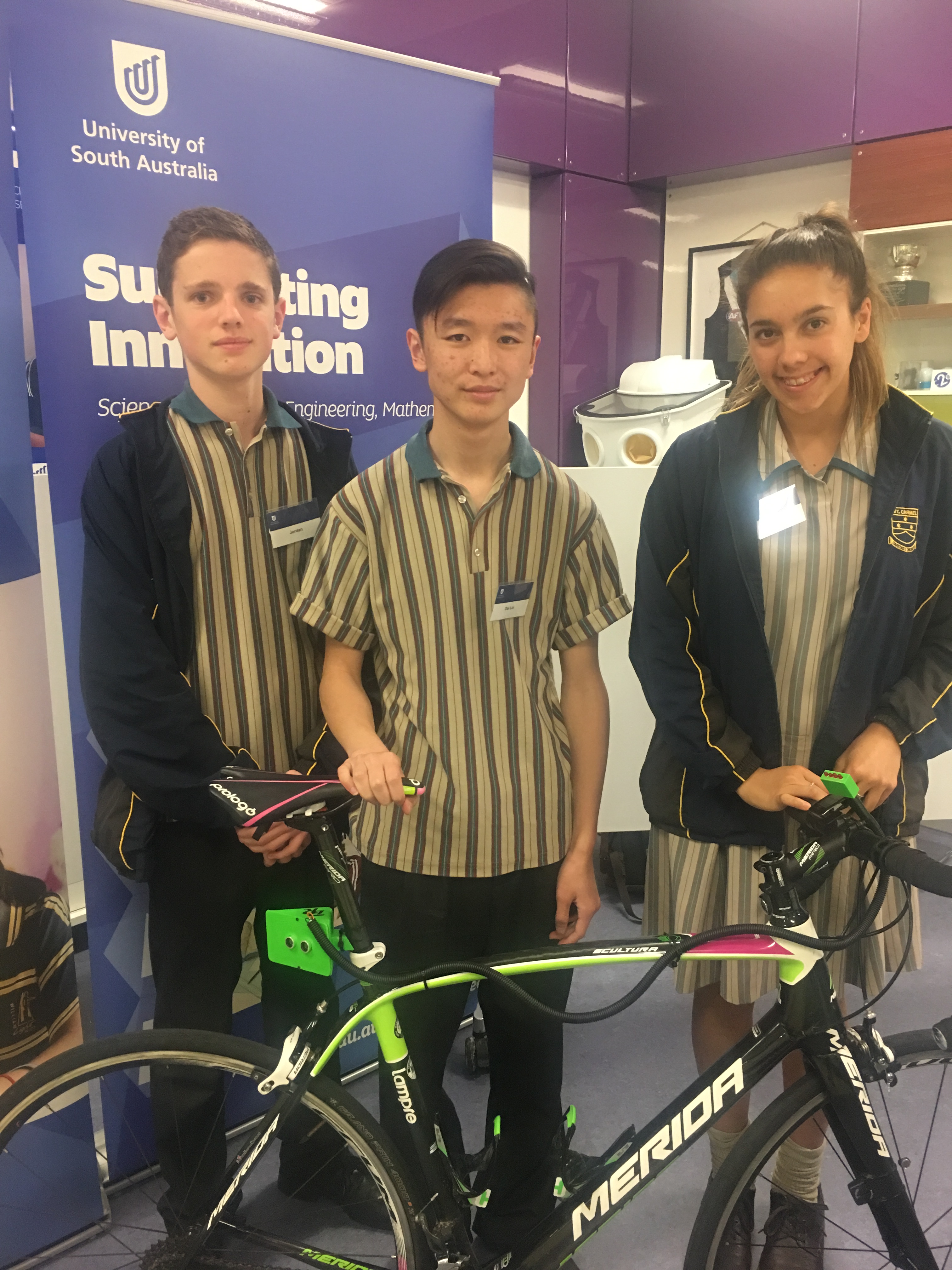 Students standing next to a bike engineered with sensors to indicate when cars are too close